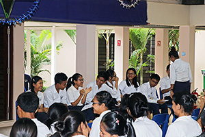 JPA Image Gallery - Seated high school students enjoying a laugh while waiting  - Jay Pritzker Academy, Siem Reap, Cambodia