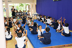 JPA Image Gallery - Young primary students perform musical piece at assembly - Jay Pritzker Academy, Siem Reap, Cambodia