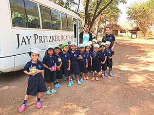 JPA Image Gallery - Kindergarten students pose in front of the JPA bus before returning to campus after their visit to the silk farm - Jay Pritzker Academy, Siem Reap, Cambodia