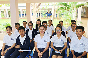 JPA Image Gallery - High school student council members smile for the camera in the assembly area - Jay Pritzker Academy, Siem Reap, Cambodia