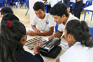 JPA Image Gallery - A group of high school students have a look at components for RCVs - Jay Pritzker Academy, Siem Reap, Cambodia