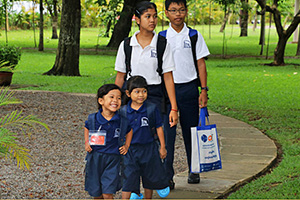 JPA Image Gallery - Older and younger students arrive together on campus - Jay Pritzker Academy, Siem Reap, Cambodia