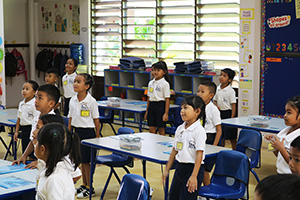 JPA Image Gallery - Grade 1 students standing for the pledge - Jay Pritzker Academy, Siem Reap, Cambodia