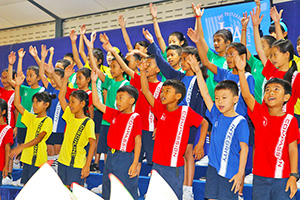 JPA Image Gallery - Primary students wearing shirts with JPA values perform at assembly  - Jay Pritzker Academy, Siem Reap, Cambodia
