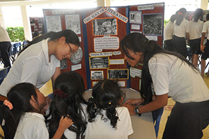 JPA Image Gallery - Young students look at older students’ display on Shakespeare - Jay Pritzker Academy, Siem Reap, Cambodia
