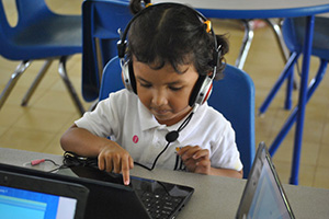 JPA Image Gallery - A young primary student works at her laptop - Jay Pritzker Academy, Siem Reap, Cambodia