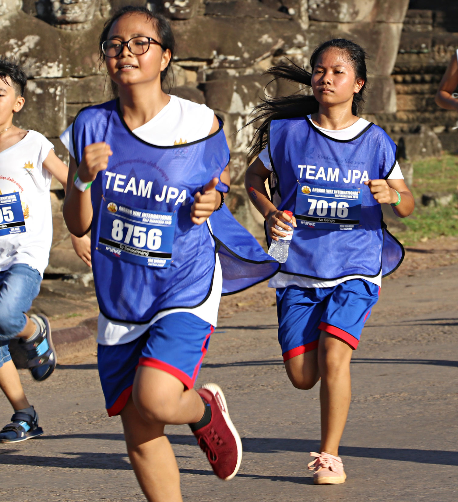 JPA students Sensomnang and Sengly running in the Angkor Wat Half Marathon. Jay Pritzker Academy, Siem Reap, Cambodia. Jay-Pritzker-Academy-Siem-Reap-Cambodia.