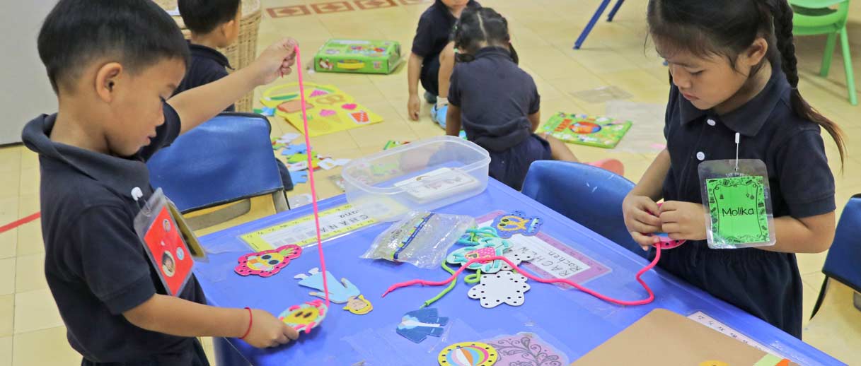 JPA Pre-Kindergarten Students learning with their Activity Packs. Jay Pritzker Academy, Siem Reap, Cambodia. Jay-Pritzker-Academy-Siem-Reap-Cambodia.