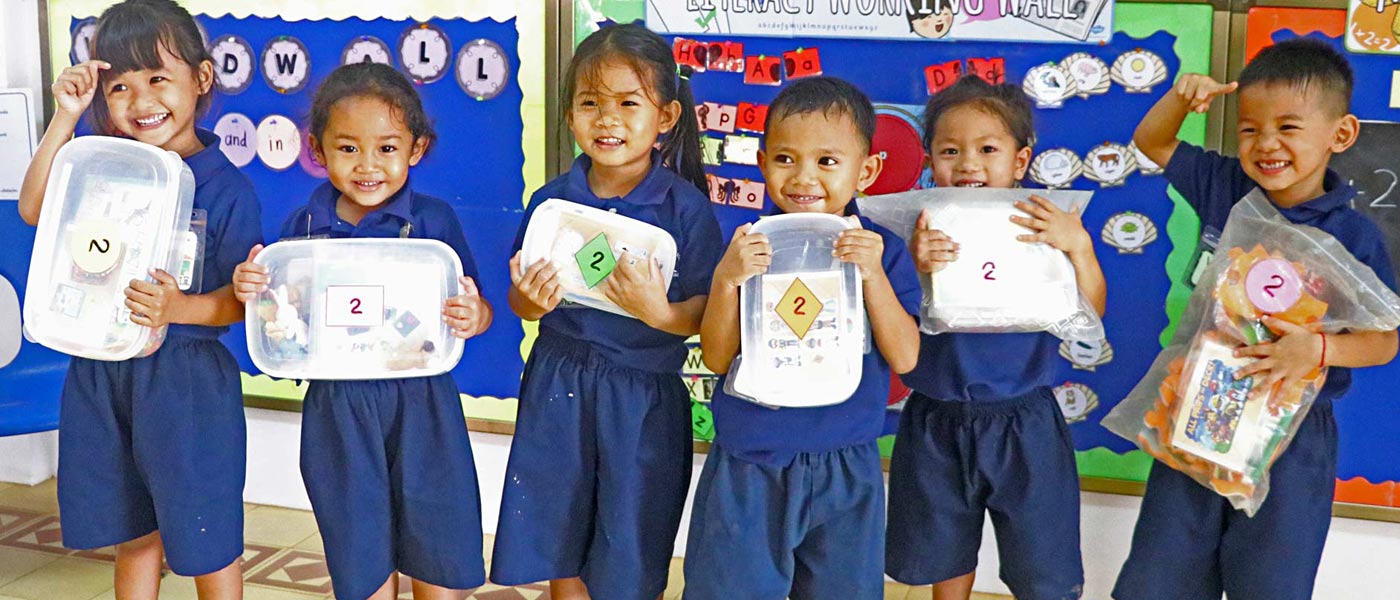 JPA Pre-Kindergarten Students Ready to Head Home with their Activity Packs. Jay Pritzker Academy, Siem Reap, Cambodia. Jay-Pritzker-Academy-Siem-Reap-Cambodia.